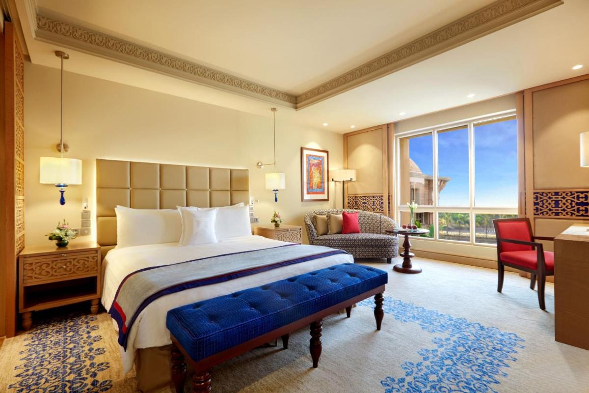 a bedroom with a large bed and a large window at ITC Maratha, a Luxury Collection Hotel, Mumbai in Mumbai