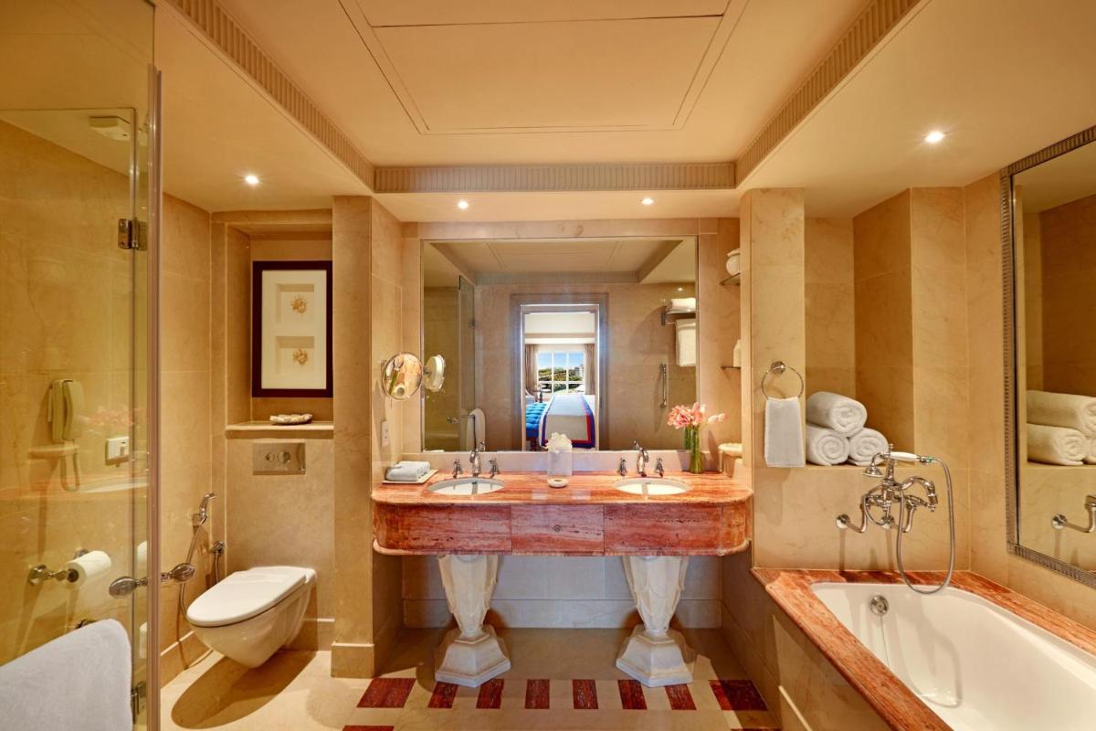 a bathroom with a sink and a tub and a toilet at ITC Maratha, a Luxury Collection Hotel, Mumbai in Mumbai