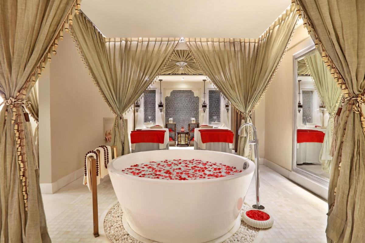 a bathroom with a large tub filled with candy canes at ITC Maratha, a Luxury Collection Hotel, Mumbai in Mumbai a bathroom with a large tub filled with candy canes at ITC Maratha, a Luxury Collection Hotel, Mumbai in Mumbai