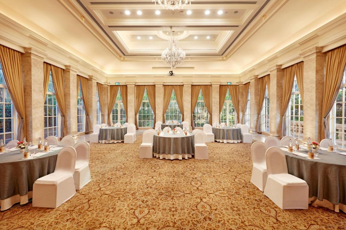 a banquet hall with tables and chairs in a room with windows at ITC Maratha, a Luxury Collection Hotel, Mumbai in Mumbai