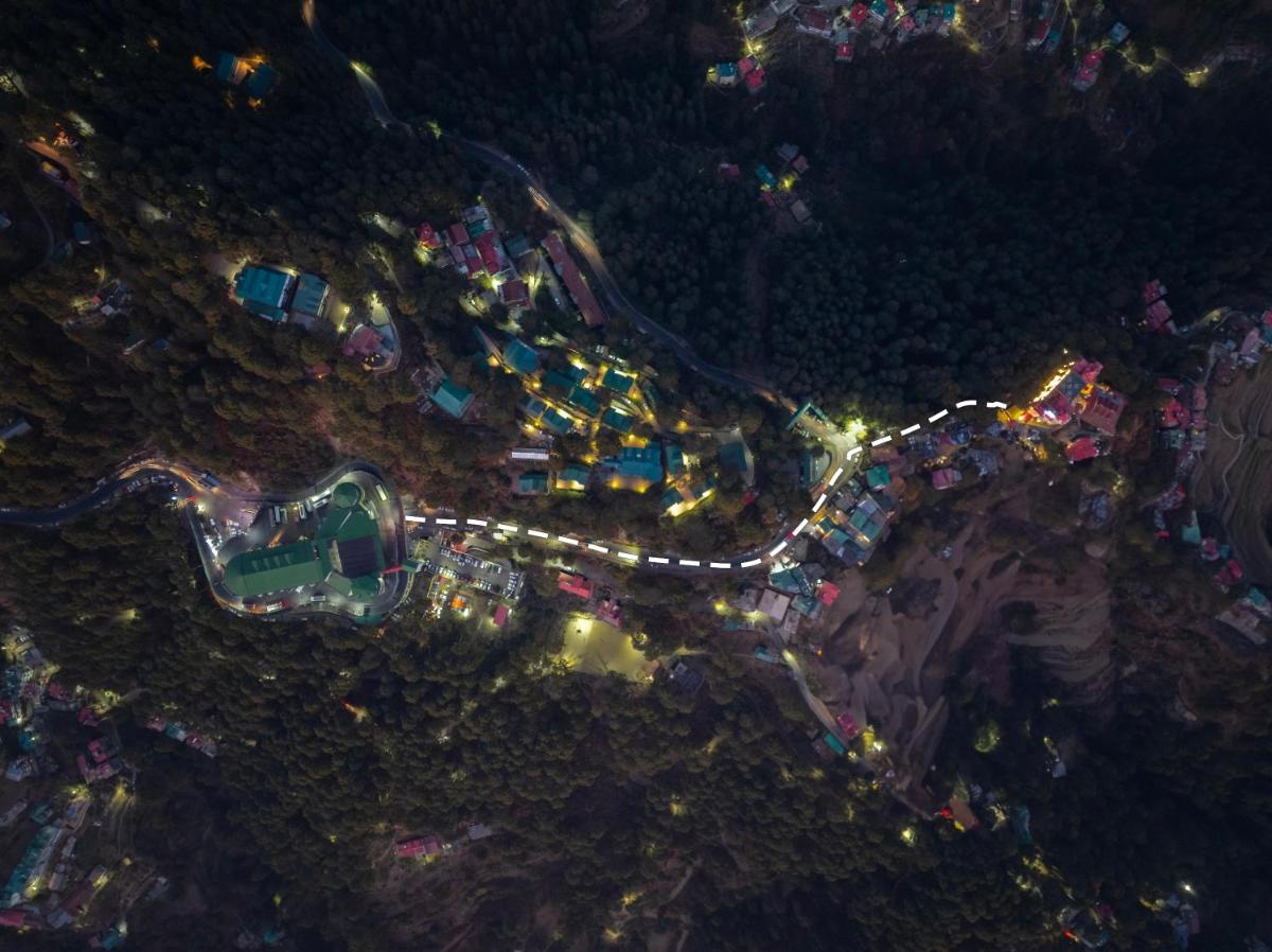 an aerial view of a city at night at WelcomHeritage Elysium Resort & Spa in Shimla
