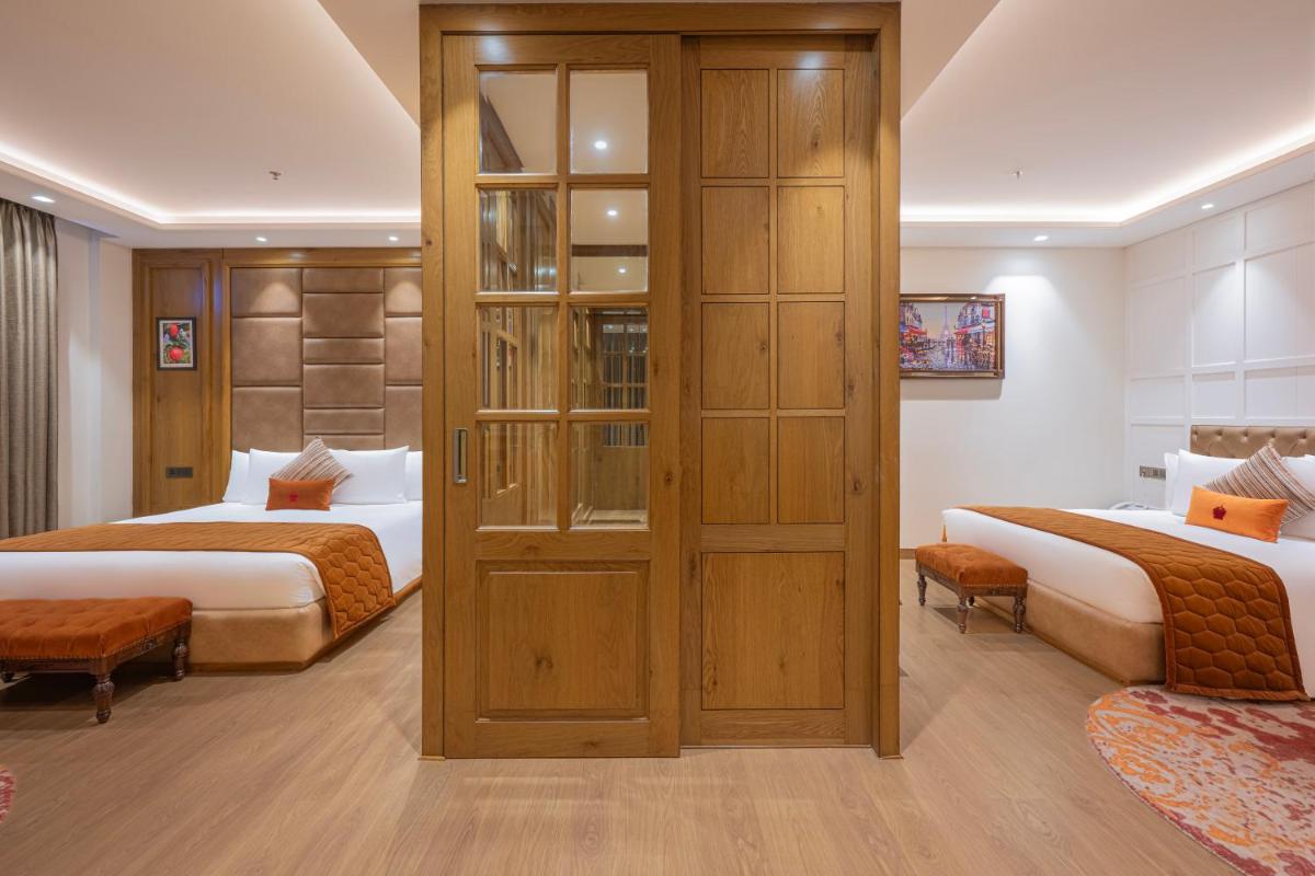 a hotel room with two beds and a closet at WelcomHeritage Elysium Resort & Spa in Shimla