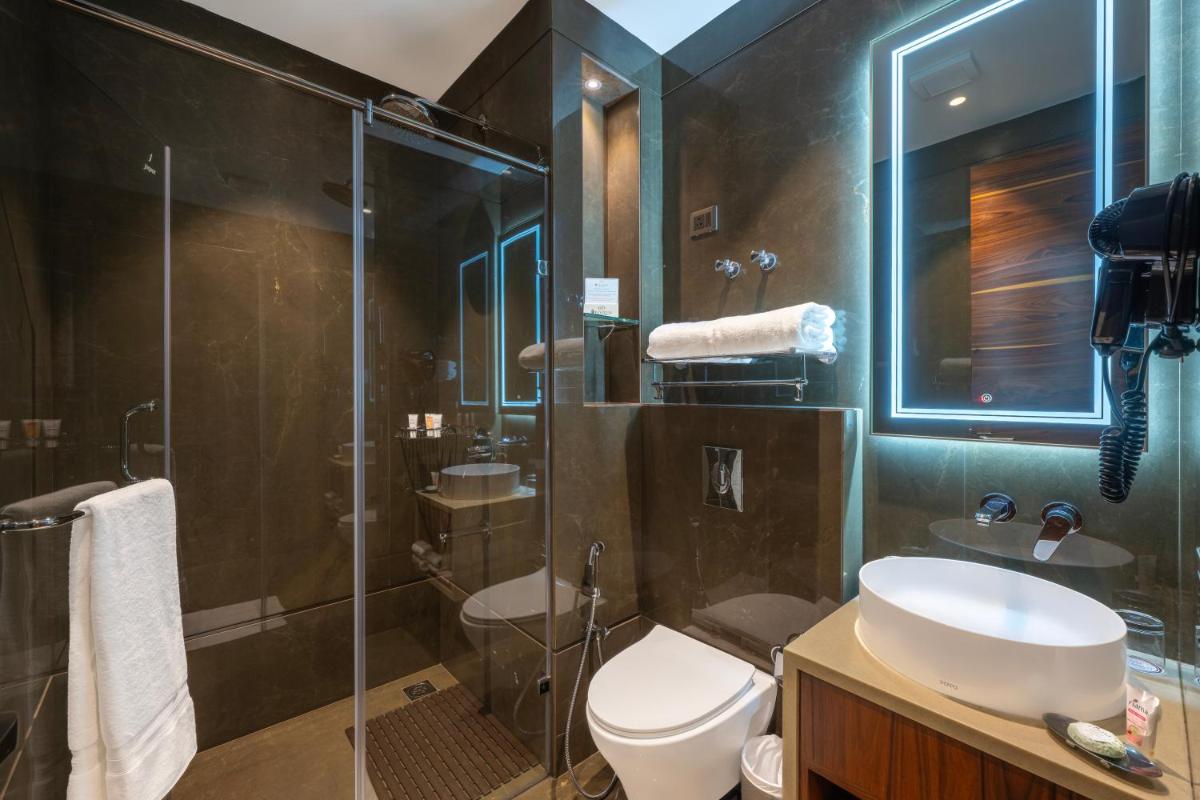 a bathroom with a toilet and a sink and a shower at WelcomHeritage Elysium Resort & Spa in Shimla