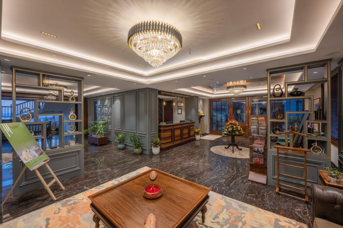 a large room with a table and a chandelier at WelcomHeritage Elysium Resort & Spa in Shimla