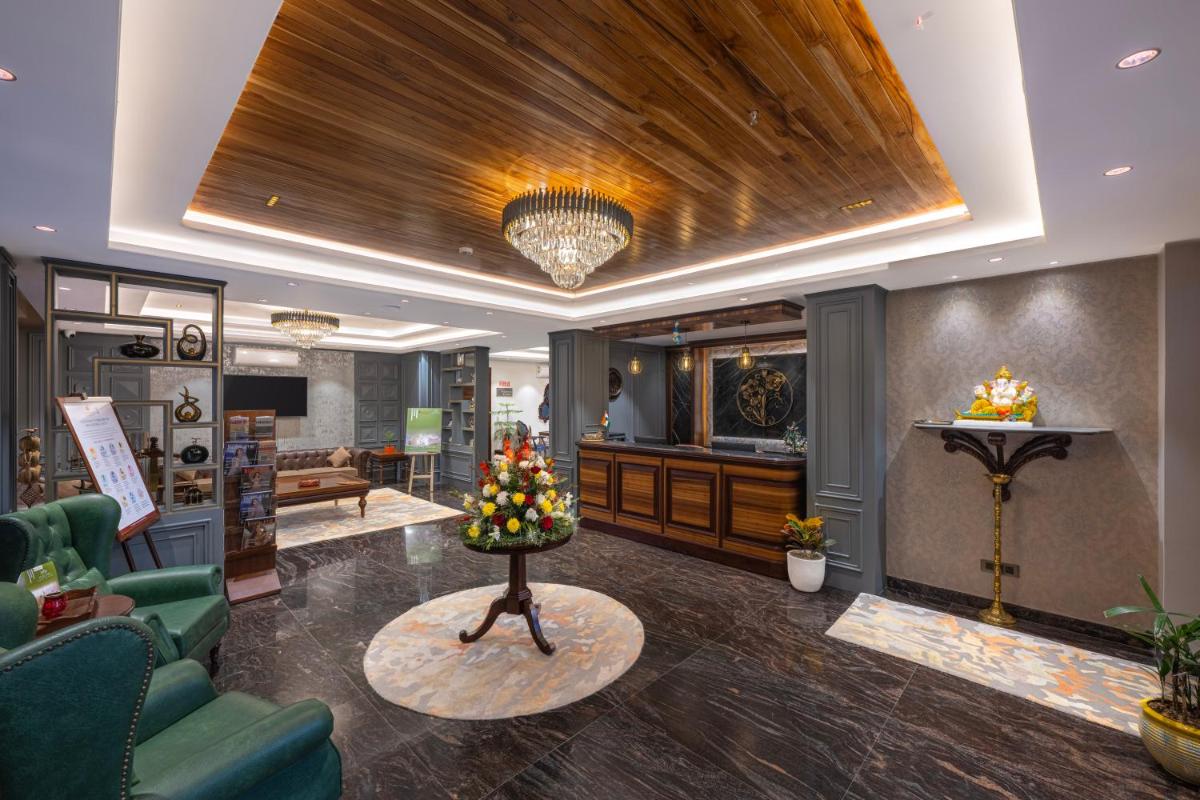 a living room with a couch and a table with fruit on it at WelcomHeritage Elysium Resort & Spa in Shimla