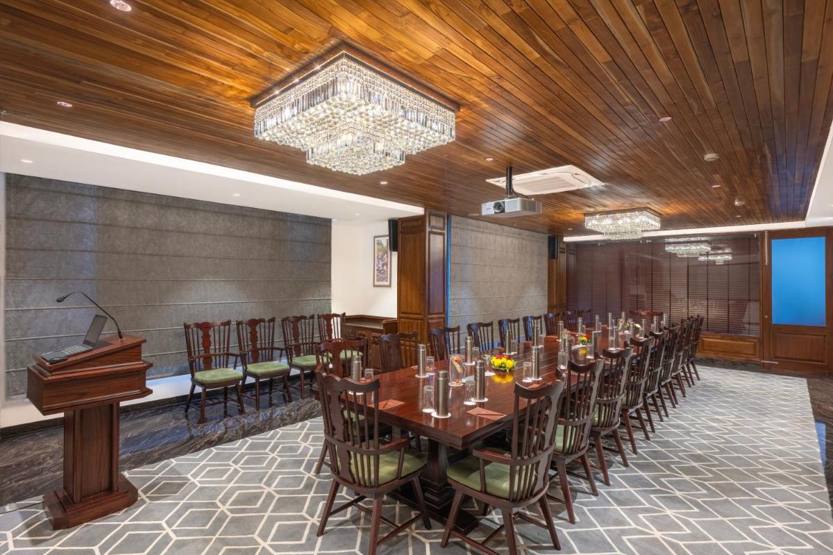 a conference room with a long table and chairs at WelcomHeritage Elysium Resort & Spa in Shimla