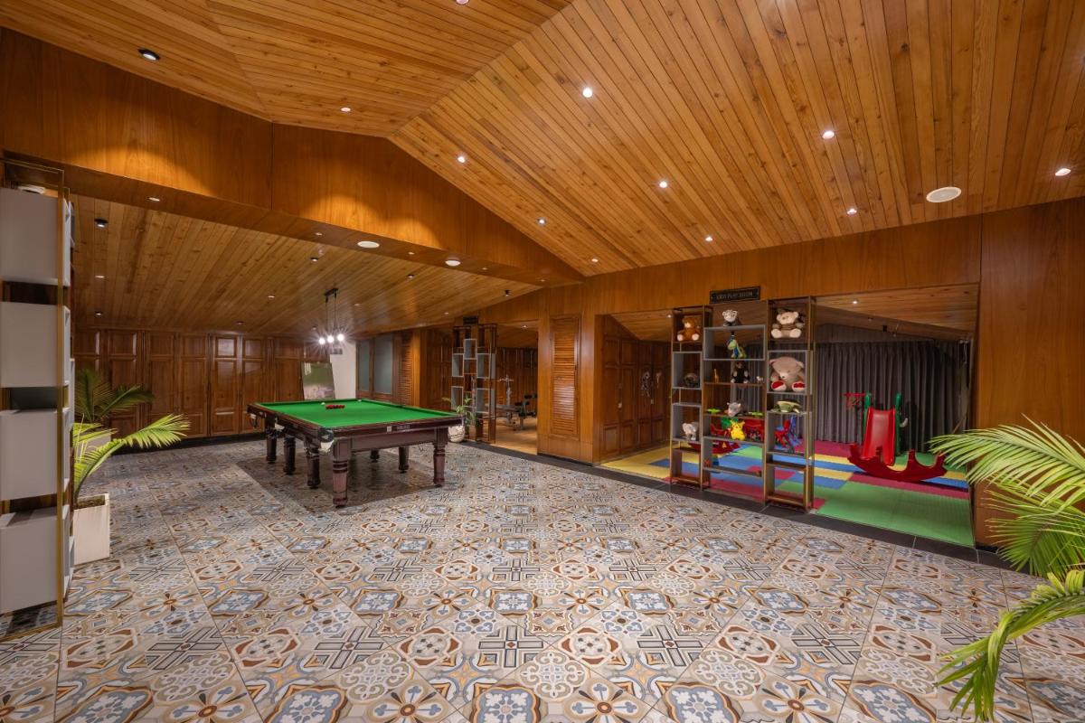 a room with a pool table and a play area at WelcomHeritage Elysium Resort & Spa in Shimla