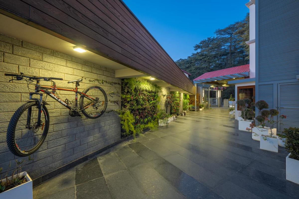 a bike hanging on the side of a building at WelcomHeritage Elysium Resort & Spa in Shimla