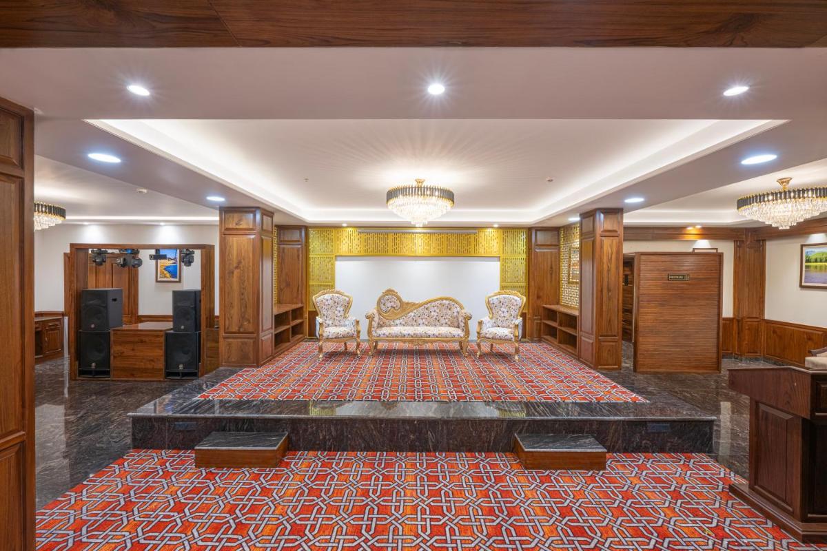a living room with two chairs and a rug at WelcomHeritage Elysium Resort & Spa in Shimla