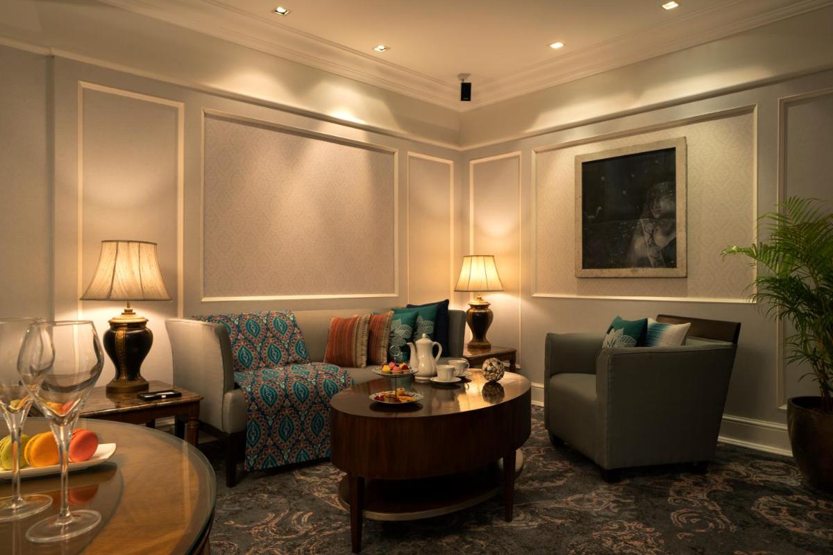 a living room with a couch and a table at Taj Lands End in Mumbai a living room with a couch and a table at Taj Lands End in Mumbai