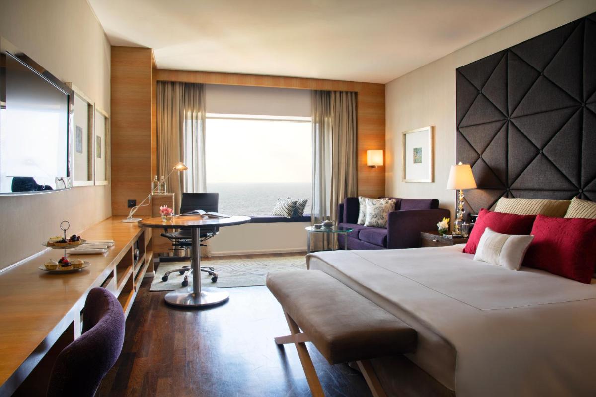 a hotel room with a bed and a desk at Taj Lands End in Mumbai a hotel room with a bed and a desk at Taj Lands End in Mumbai