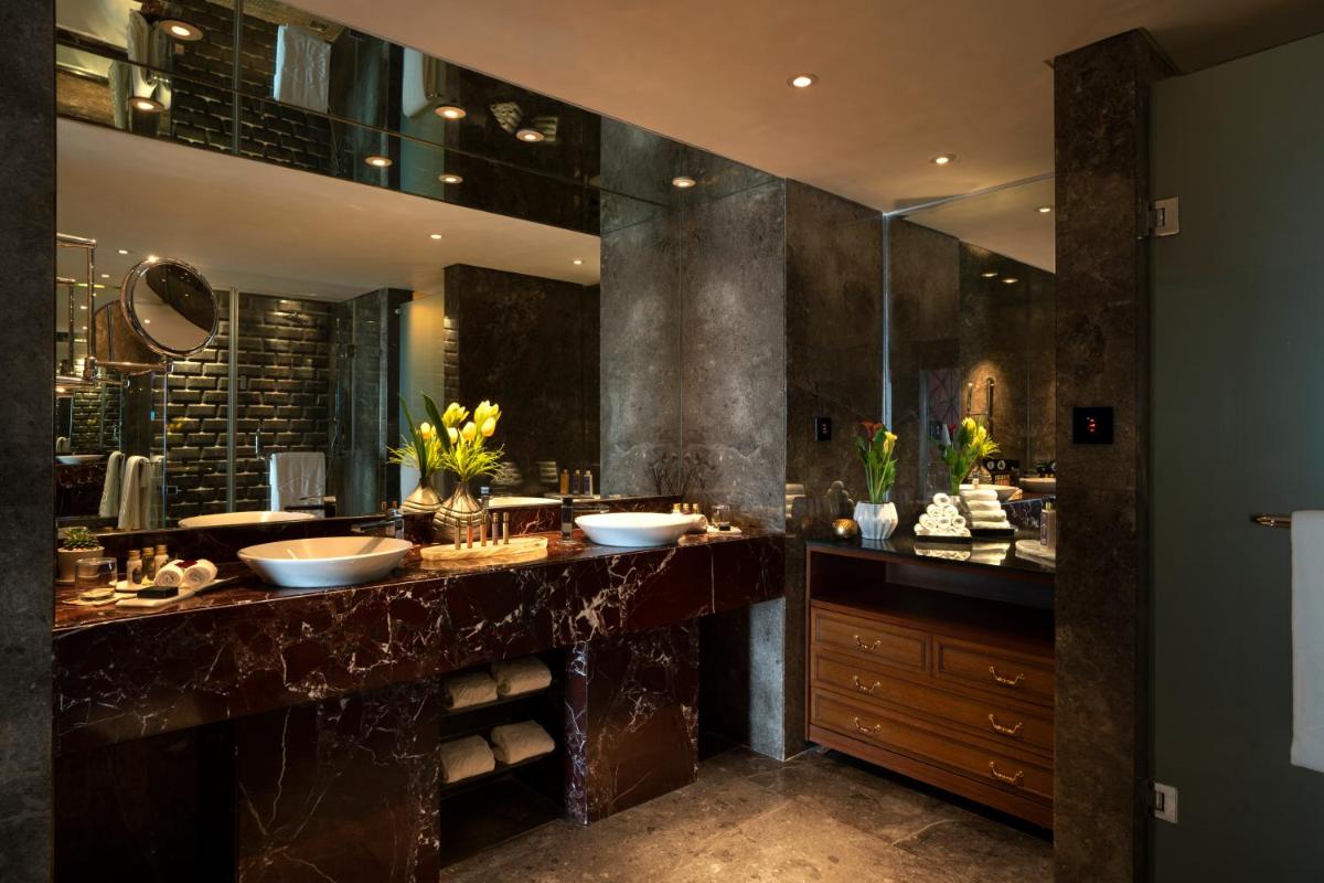 a bathroom with two sinks and a large mirror at Taj Lands End in Mumbai a bathroom with two sinks and a large mirror at Taj Lands End in Mumbai