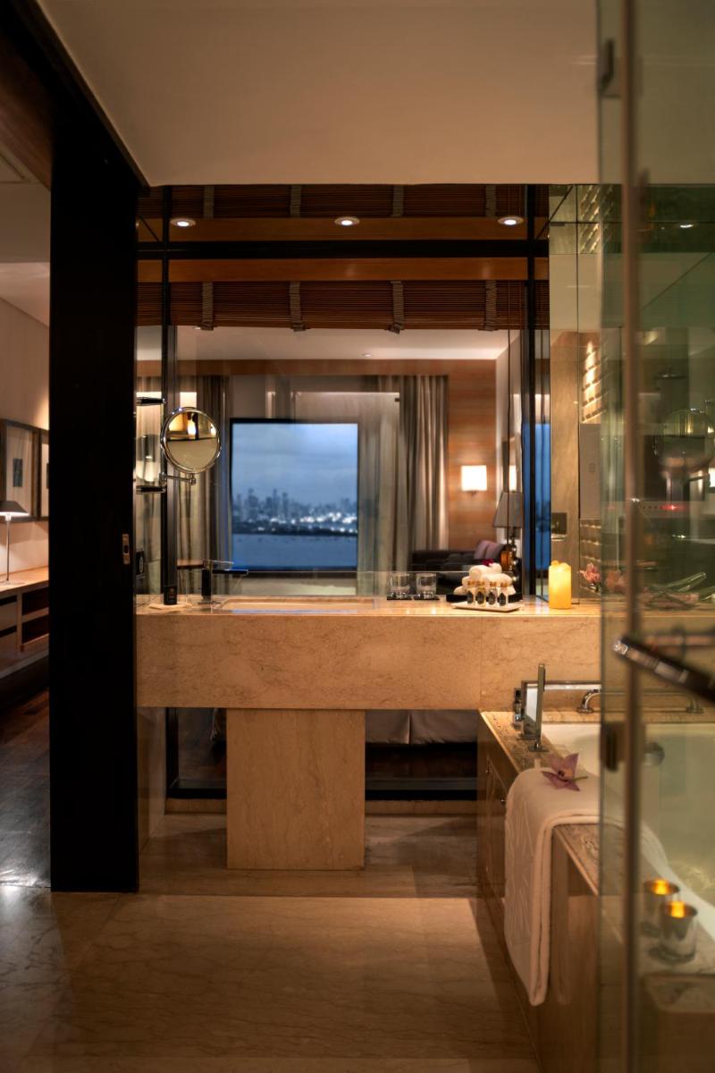a bathroom with a large counter with a television in it at Taj Lands End in Mumbai a bathroom with a large counter with a television in it at Taj Lands End in Mumbai