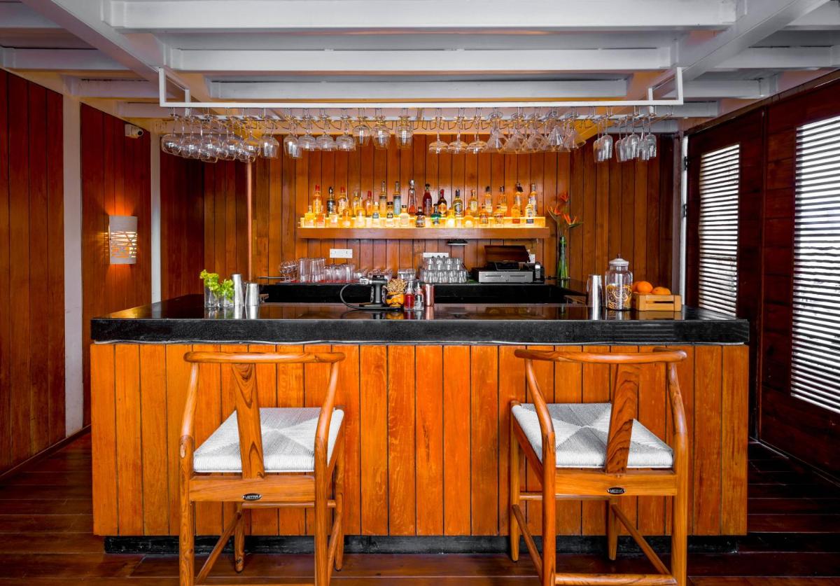 a bar with two chairs and a counter with drinks at The Park Bangalore, MG Road in Bengaluru a bar with two chairs and a counter with drinks at The Park Bangalore, MG Road in Bengaluru