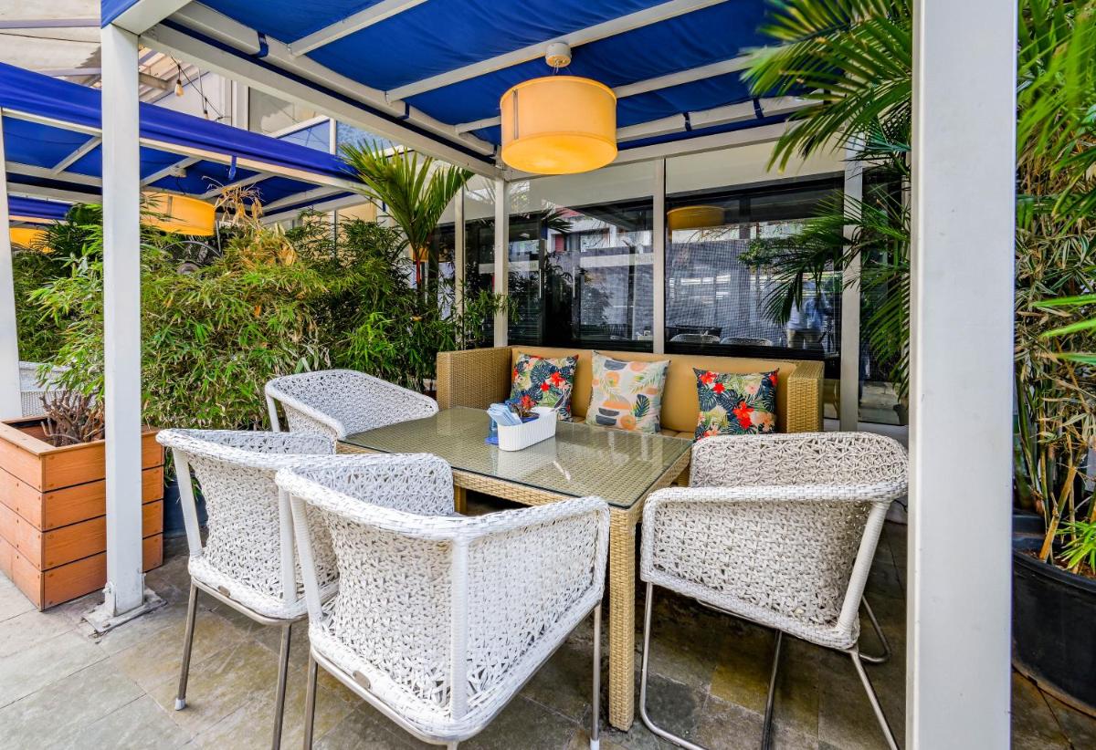 a table and chairs on a patio at The Park Bangalore, MG Road in Bengaluru a table and chairs on a patio at The Park Bangalore, MG Road in Bengaluru