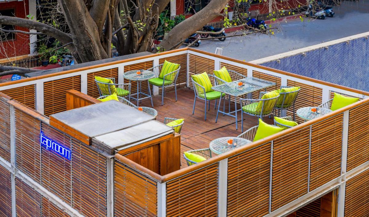 an outdoor patio with chairs and tables and a fence at The Park Bangalore, MG Road in Bengaluru an outdoor patio with chairs and tables and a fence at The Park Bangalore, MG Road in Bengaluru
