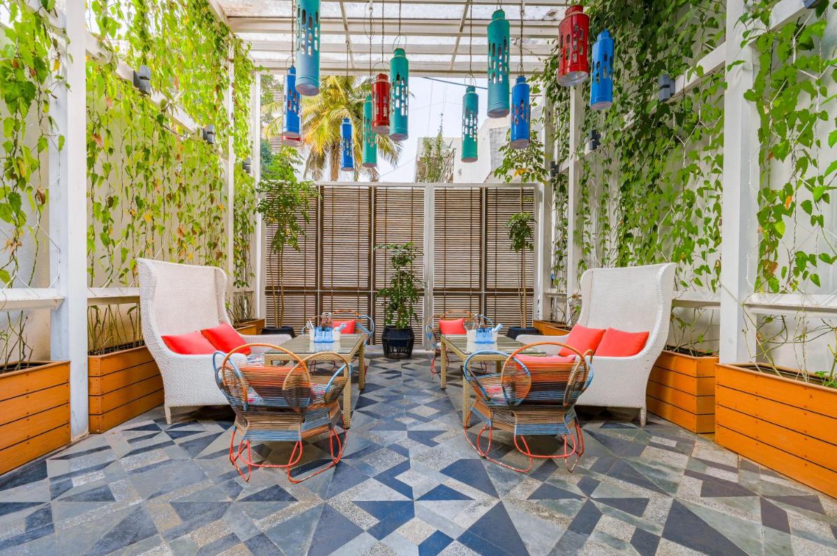 a patio with chairs and a table in a building at The Park Bangalore, MG Road in Bengaluru a patio with chairs and a table in a building at The Park Bangalore, MG Road in Bengaluru