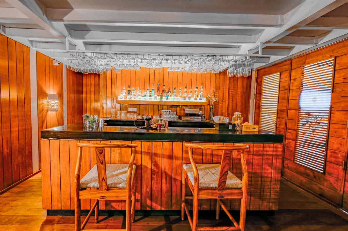 a bar with wooden walls and wooden stools at The Park Bangalore, MG Road in Bengaluru a bar with wooden walls and wooden stools at The Park Bangalore, MG Road in Bengaluru