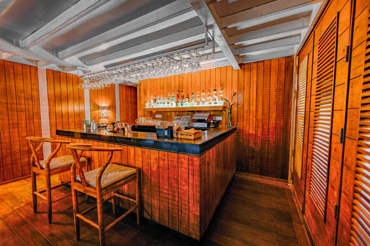 a bar with wooden walls and chairs in a room at The Park Bangalore, MG Road in Bengaluru a bar with wooden walls and chairs in a room at The Park Bangalore, MG Road in Bengaluru