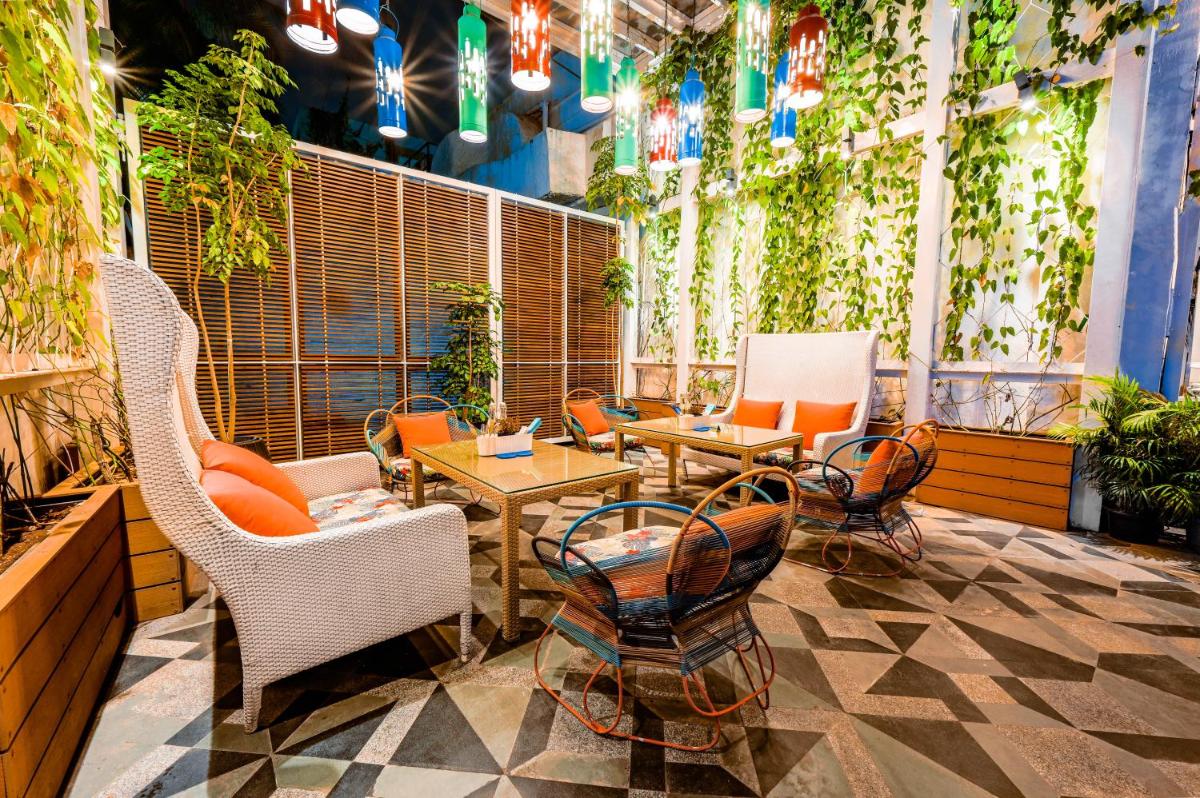 a patio with chairs and tables and plants at The Park Bangalore, MG Road in Bengaluru a patio with chairs and tables and plants at The Park Bangalore, MG Road in Bengaluru