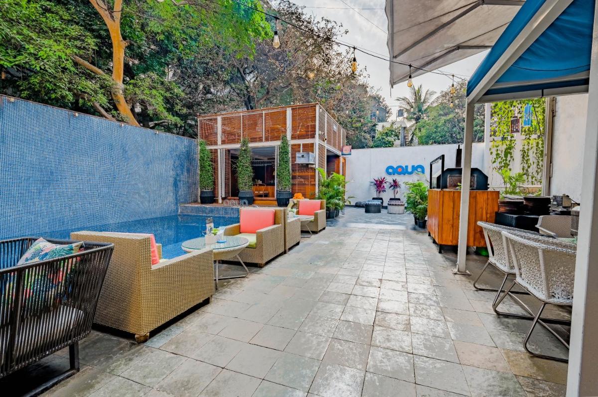 a patio with chairs and tables and a building at The Park Bangalore, MG Road in Bengaluru a patio with chairs and tables and a building at The Park Bangalore, MG Road in Bengaluru