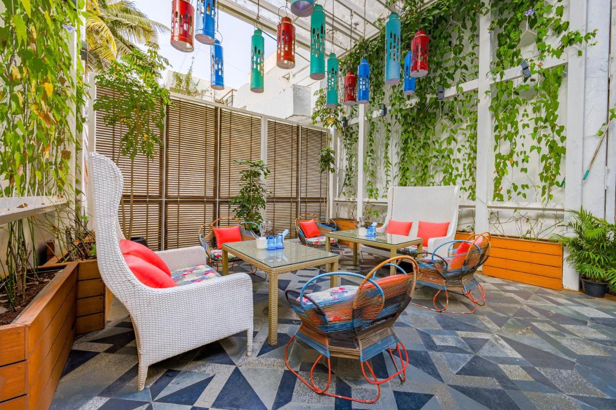 a patio with chairs and tables and plants at The Park Bangalore, MG Road in Bengaluru a patio with chairs and tables and plants at The Park Bangalore, MG Road in Bengaluru