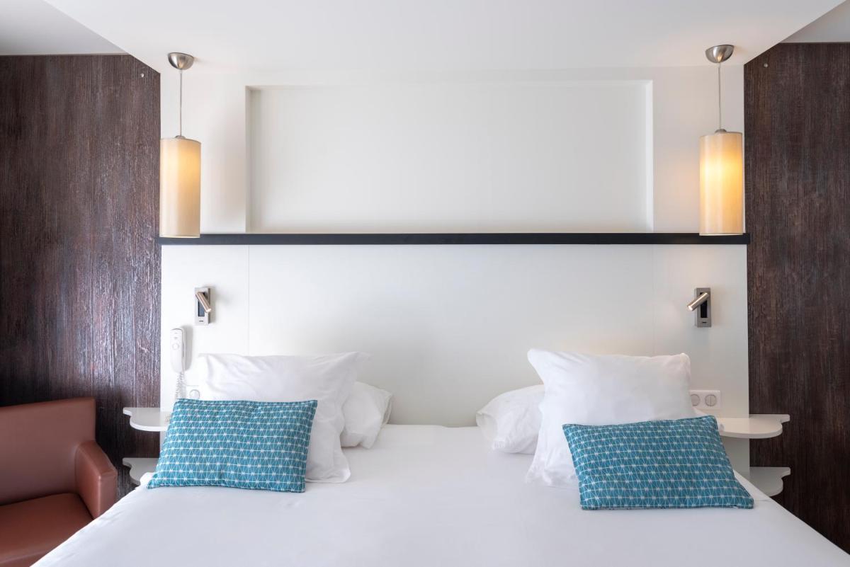 Un ou plusieurs lits dans un hébergement de l'établissement Côté Thalasso Hôtel & Spa Marin