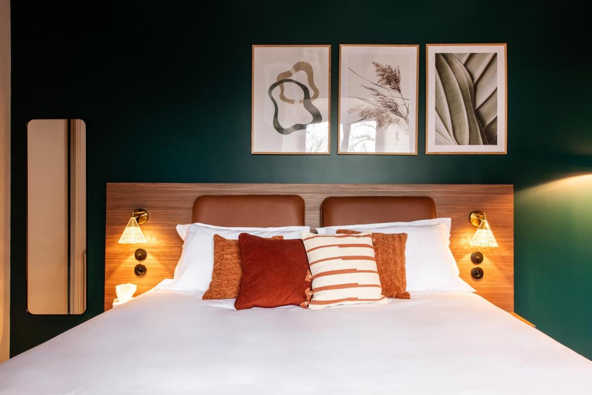 Un ou plusieurs lits dans un hébergement de l'établissement La Maison OBONO Hôtel & Spa