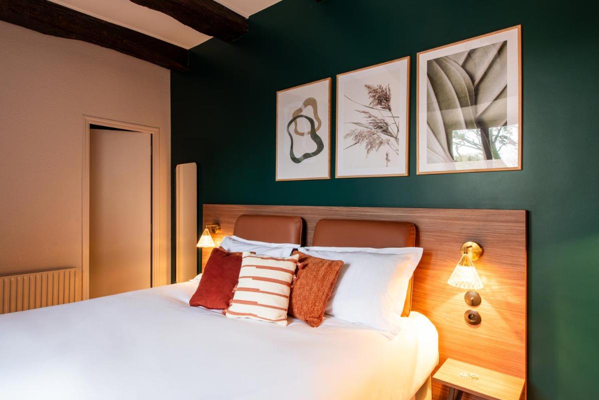 Un ou plusieurs lits dans un hébergement de l'établissement La Maison OBONO Hôtel & Spa