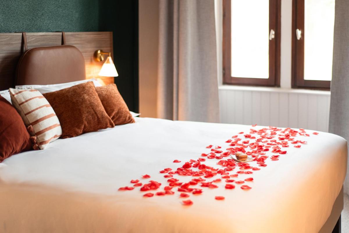 Un ou plusieurs lits dans un hébergement de l'établissement La Maison OBONO Hôtel & Spa