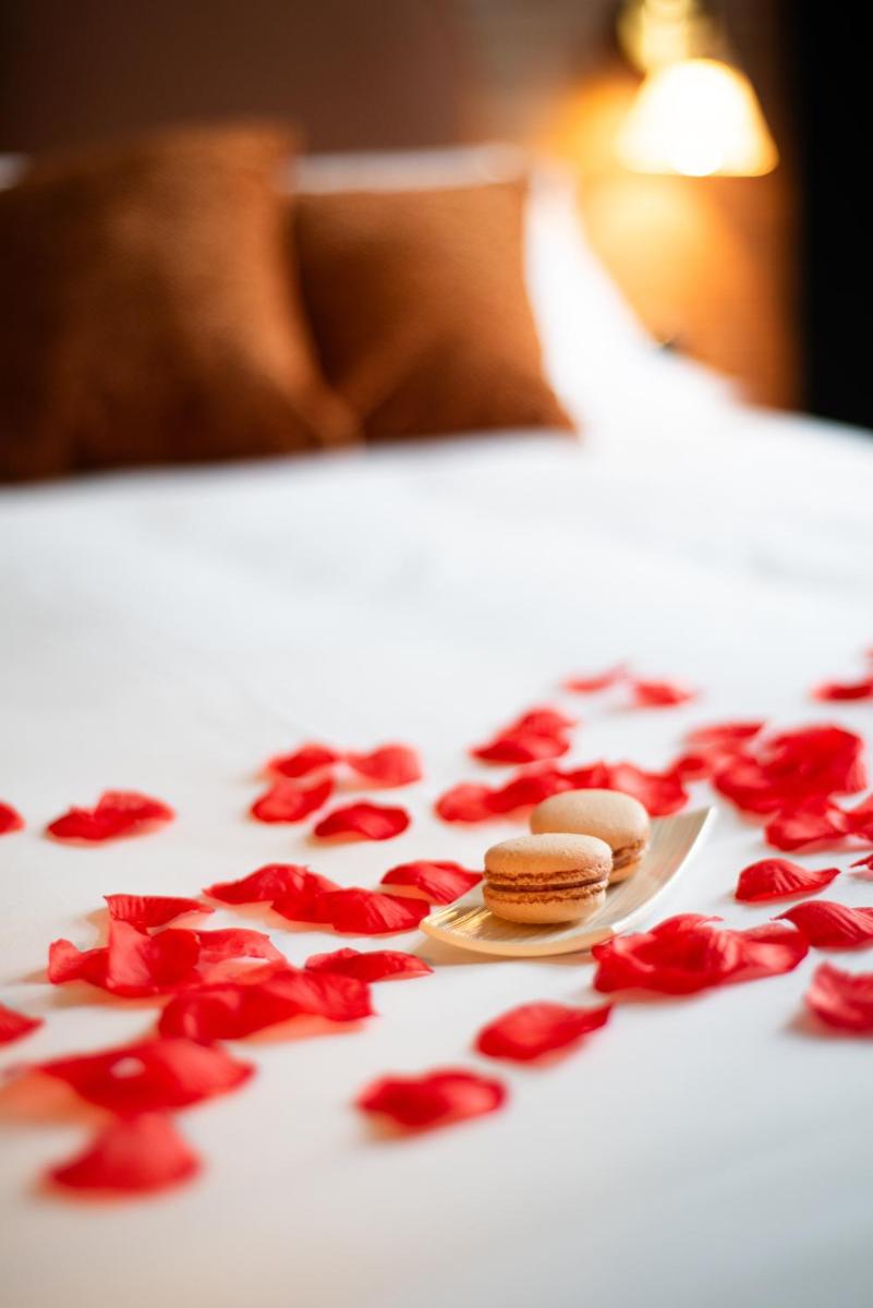 Un ou plusieurs lits dans un hébergement de l'établissement La Maison OBONO Hôtel & Spa