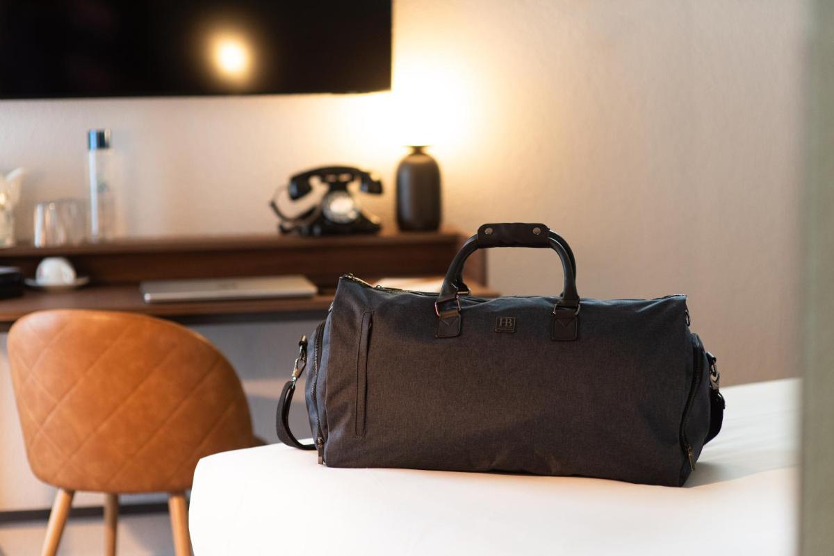 Télévision ou salle de divertissement dans l'établissement La Maison OBONO Hôtel & Spa