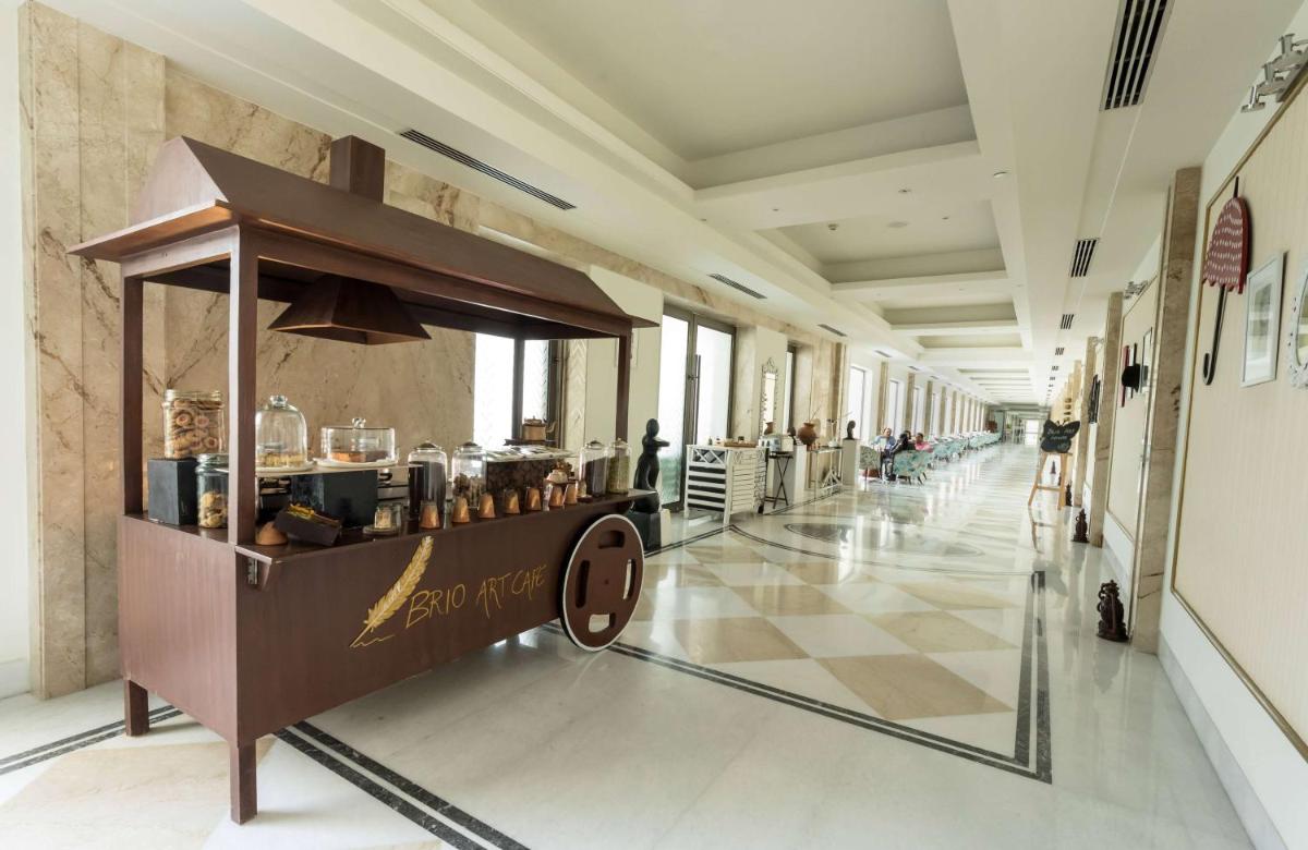 a food cart in a hallway in a building at Ramada Plaza by Wyndham Lucknow in Lucknow