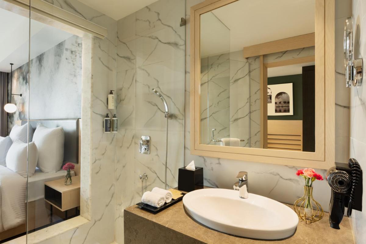 a bathroom with a sink and a shower at Novotel Jaipur Convention Centre in Jaipur