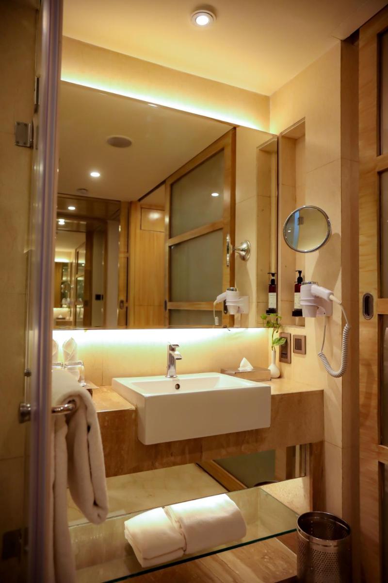 a bathroom with a sink and a mirror at Hotel Royal Orchid Jaipur, Tonk Road in Jaipur