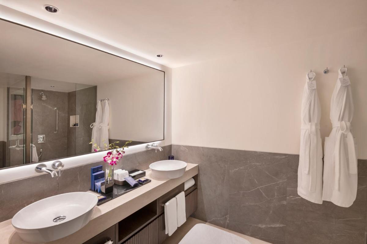 a bathroom with a sink and a mirror at The Oberoi Mumbai in Mumbai