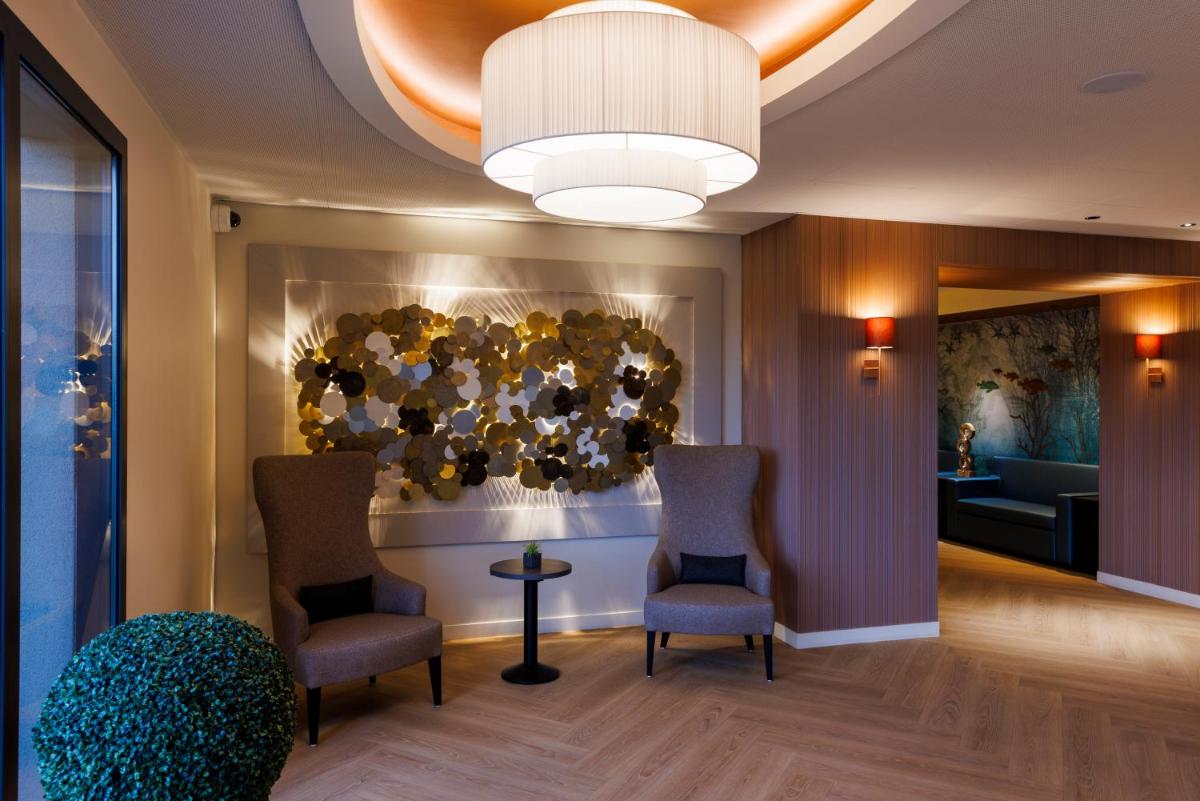Coin salon dans l'établissement Les Boréales - Appart'hotel & Restaurant