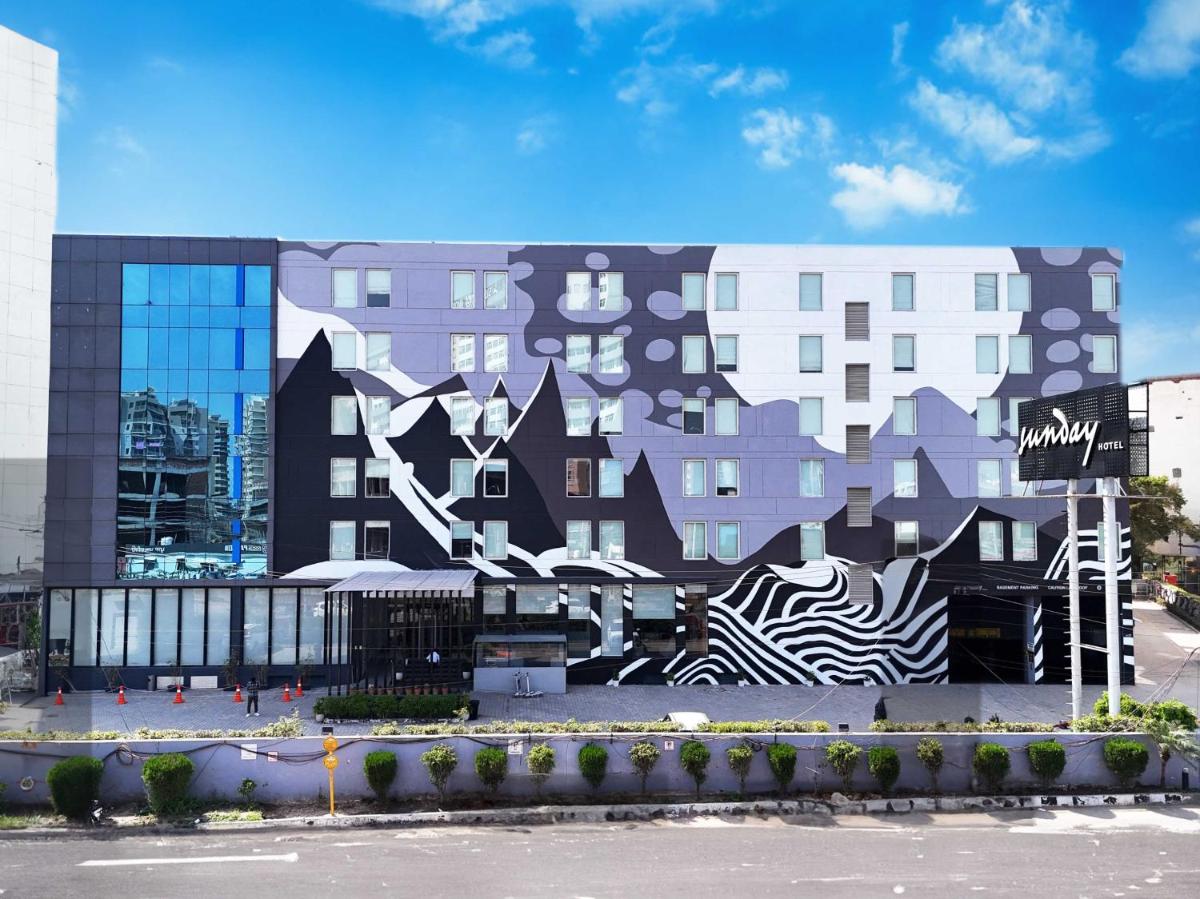 a building with a painting on the side of it at Sunday Hotel Chandigarh Zirakpur in Zirakpur
