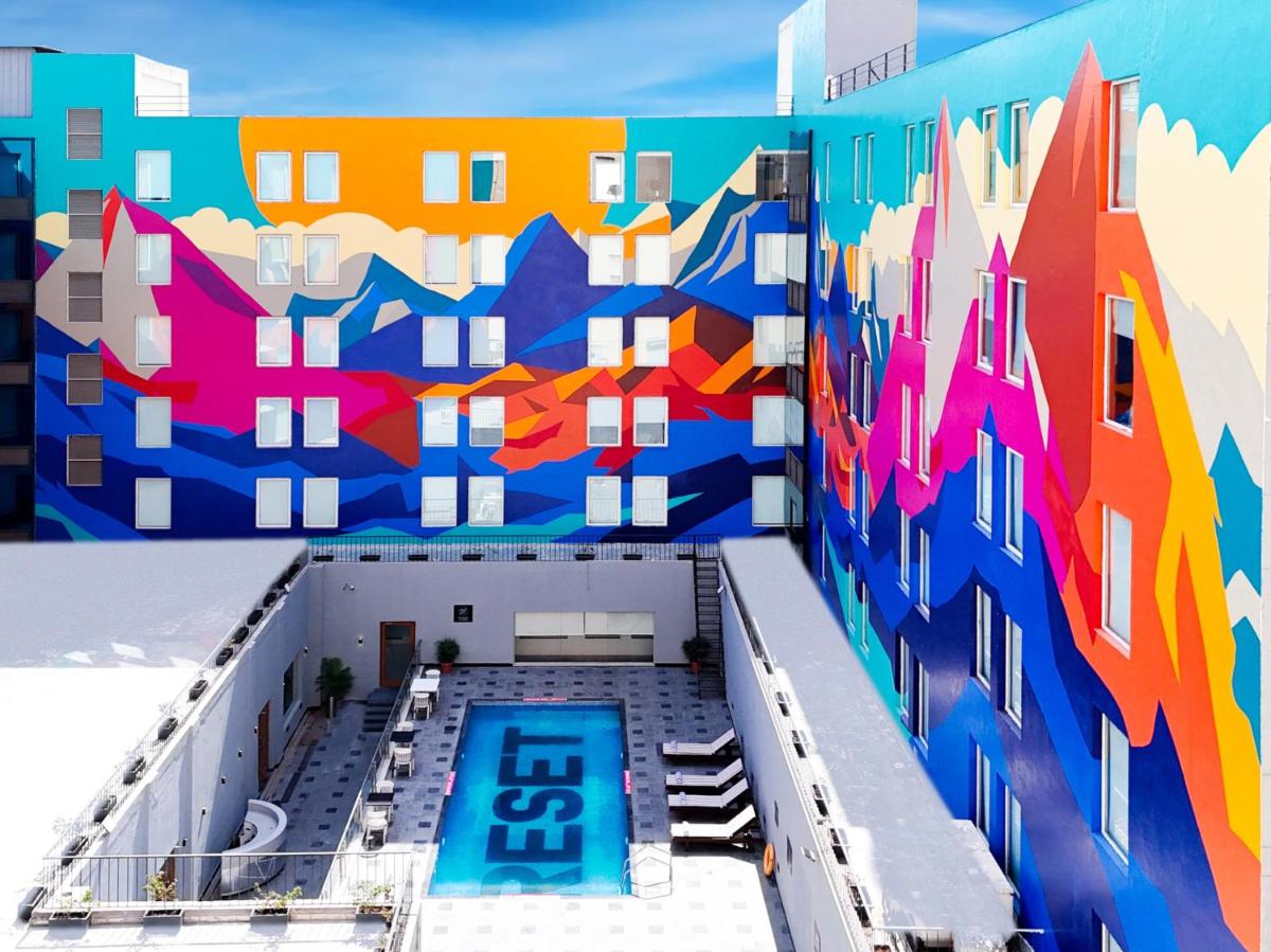 a building with a mural on the side of it at Sunday Hotel Chandigarh Zirakpur in Zirakpur