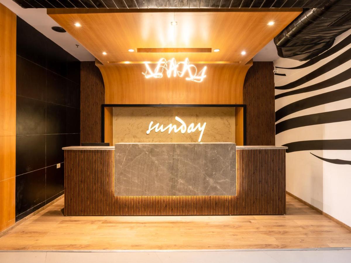 a lobby with a sign that reads unhappy at Sunday Hotel Chandigarh Zirakpur in Zirakpur