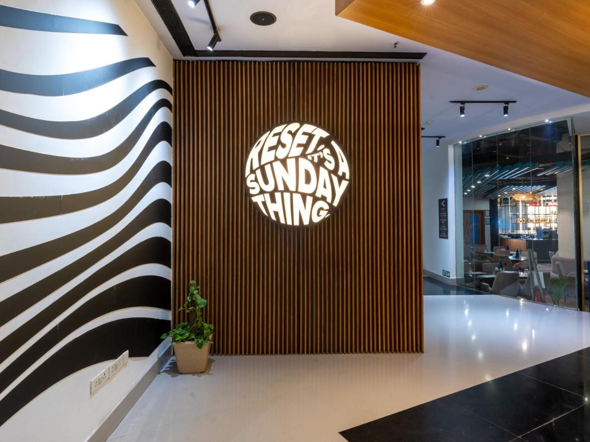 a lobby with a black and white striped wall at Sunday Hotel Chandigarh Zirakpur in Zirakpur