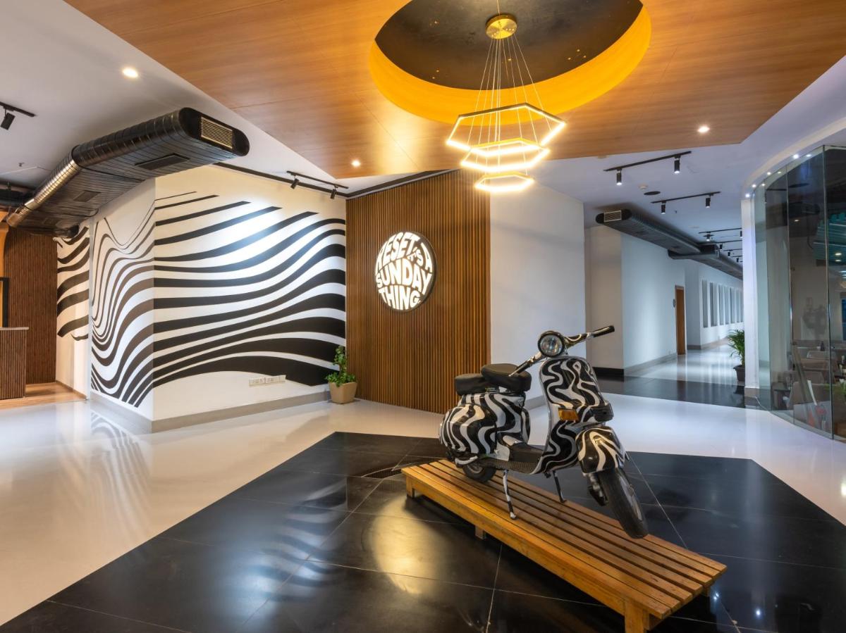 a room with a sculpture on a bench at Sunday Hotel Chandigarh Zirakpur in Zirakpur