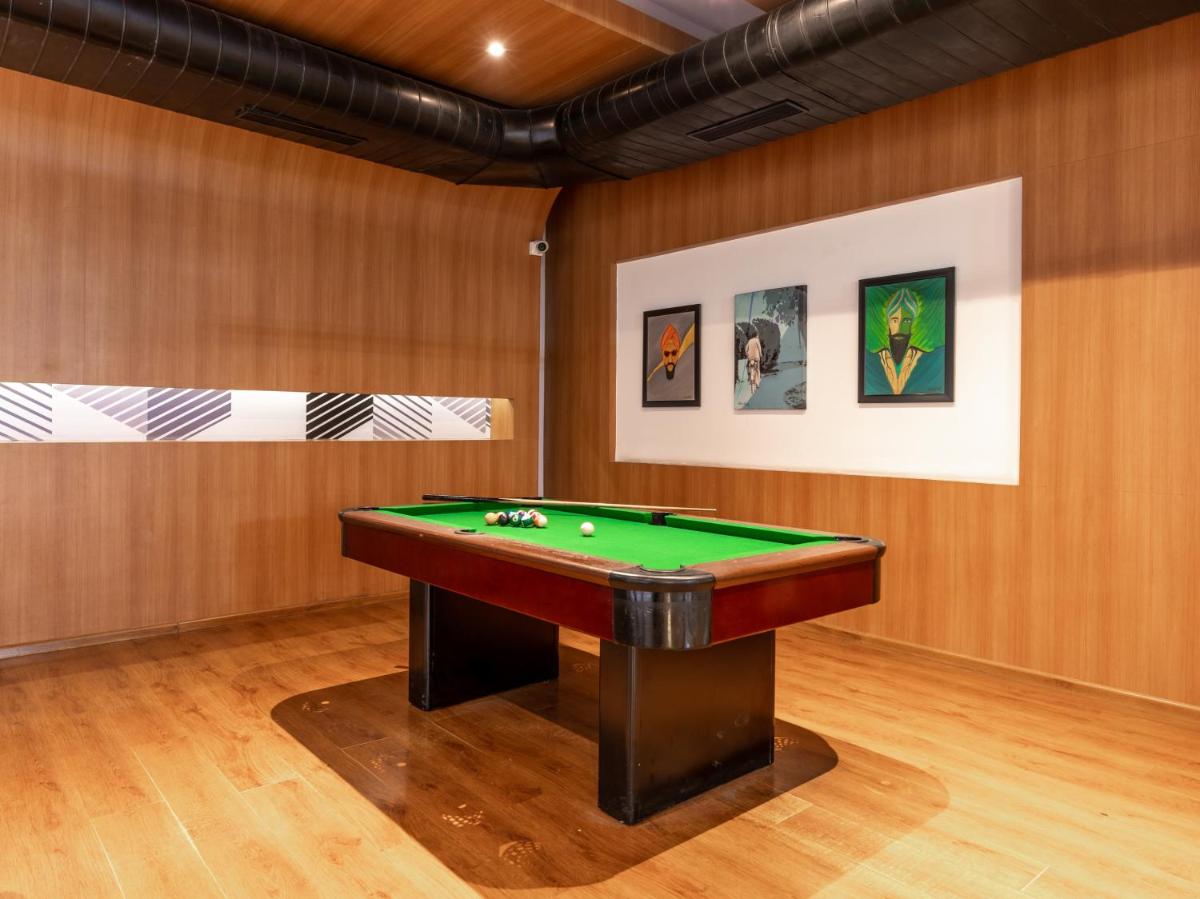 a billiard room with a green pool table at Sunday Hotel Chandigarh Zirakpur in Zirakpur