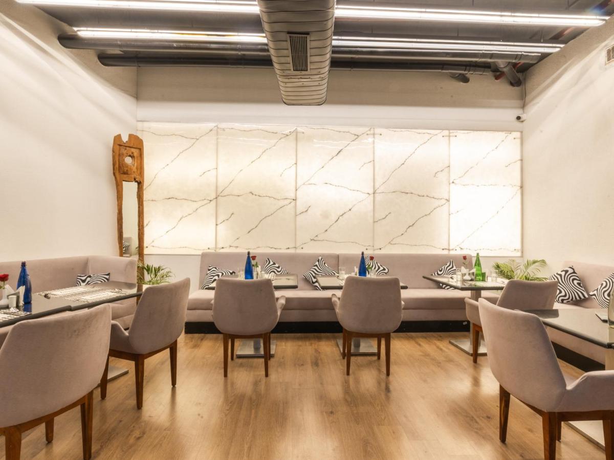 a dining room with a long table and chairs at Sunday Hotel Chandigarh Zirakpur in Zirakpur