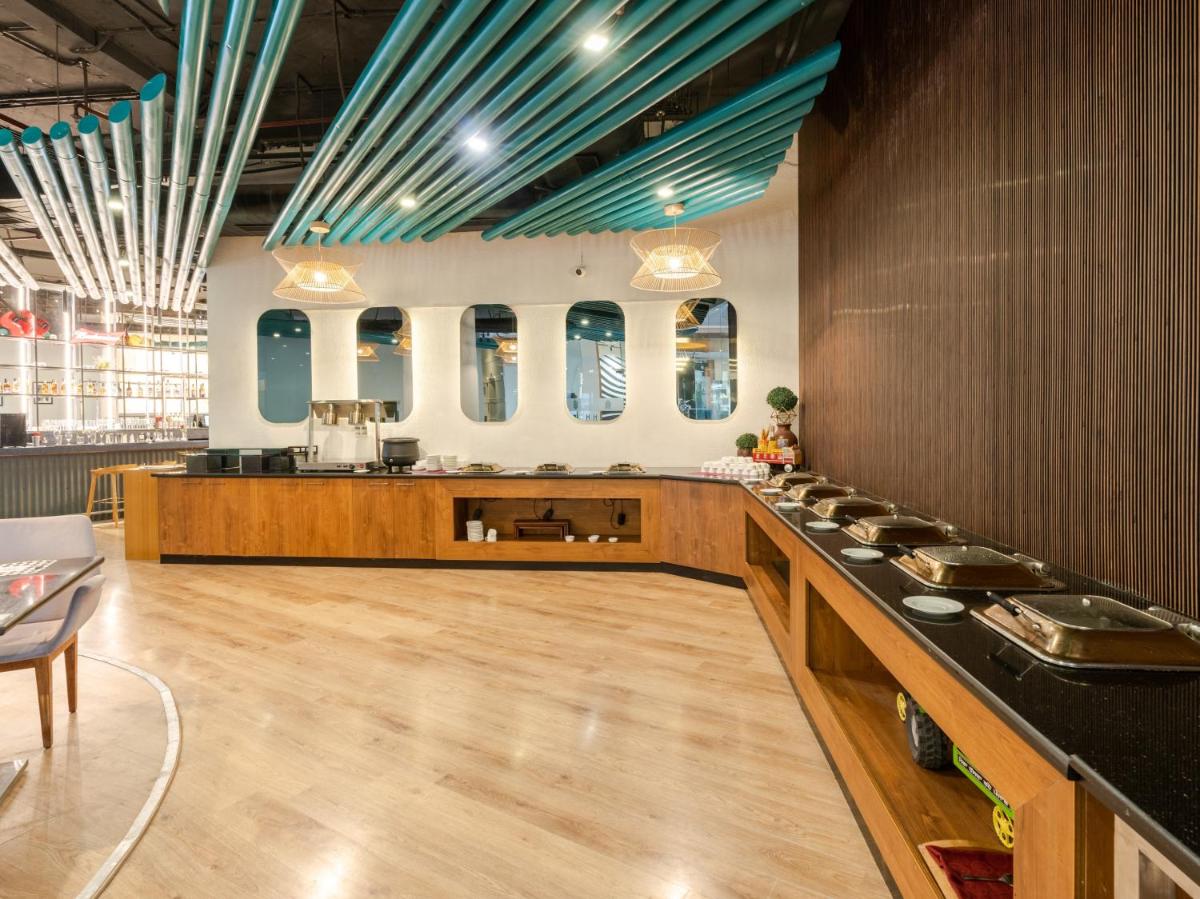 a large room with a counter with a counter top at Sunday Hotel Chandigarh Zirakpur in Zirakpur
