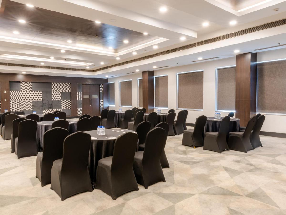 a conference room with black chairs and tables in it at Sunday Hotel Chandigarh Zirakpur in Zirakpur