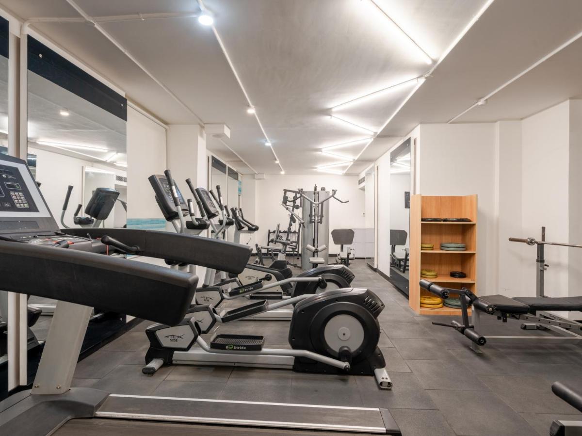 a gym with several treadmills and cardio machines at Sunday Hotel Chandigarh Zirakpur in Zirakpur