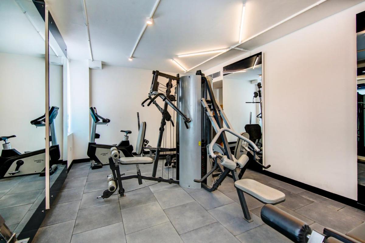 a gym with treadmills and exercise equipment in a room at Sunday Hotel Chandigarh Zirakpur in Zirakpur