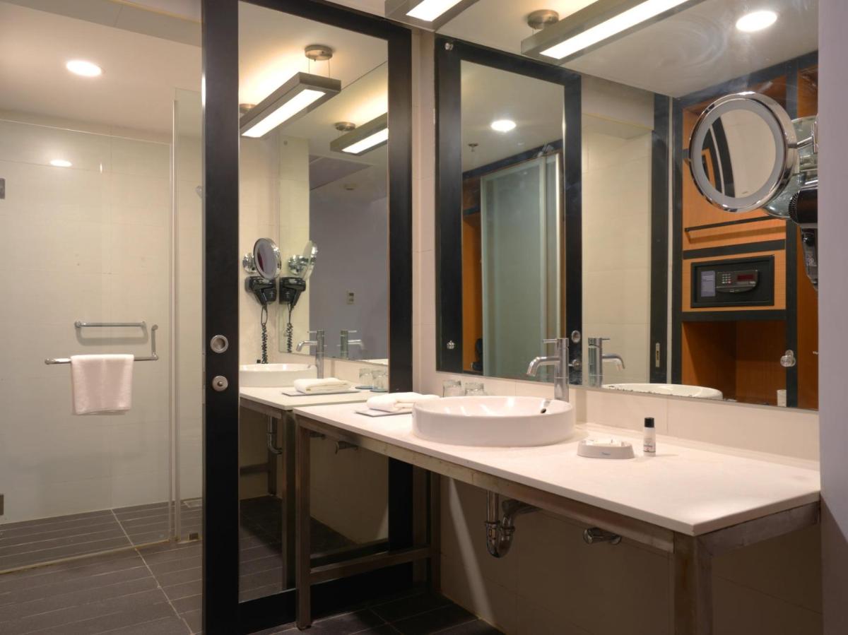 a bathroom with two sinks and a large mirror at Sunday Hotel Chandigarh Zirakpur in Zirakpur