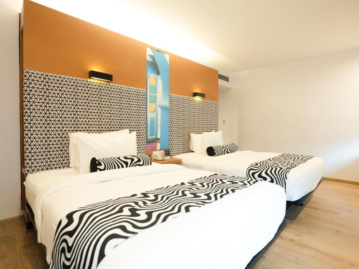 two beds sitting next to each other in a room at Sunday Hotel Chandigarh Zirakpur in Zirakpur